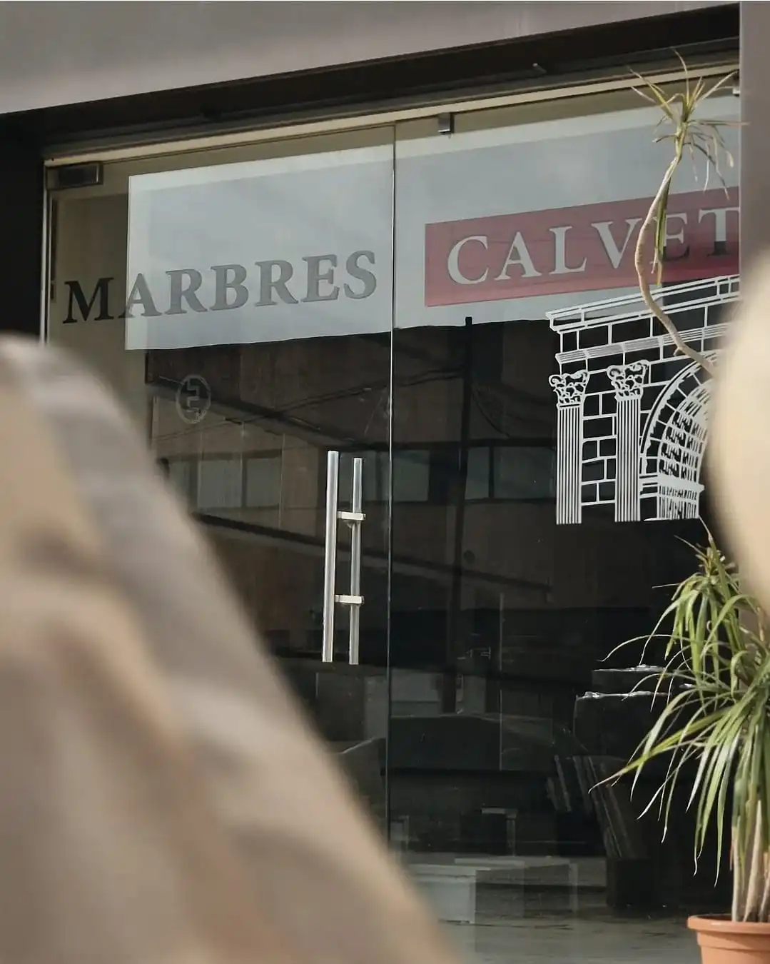 Entrada del taller amb el rètol Marbres Calvet gravat al vidre